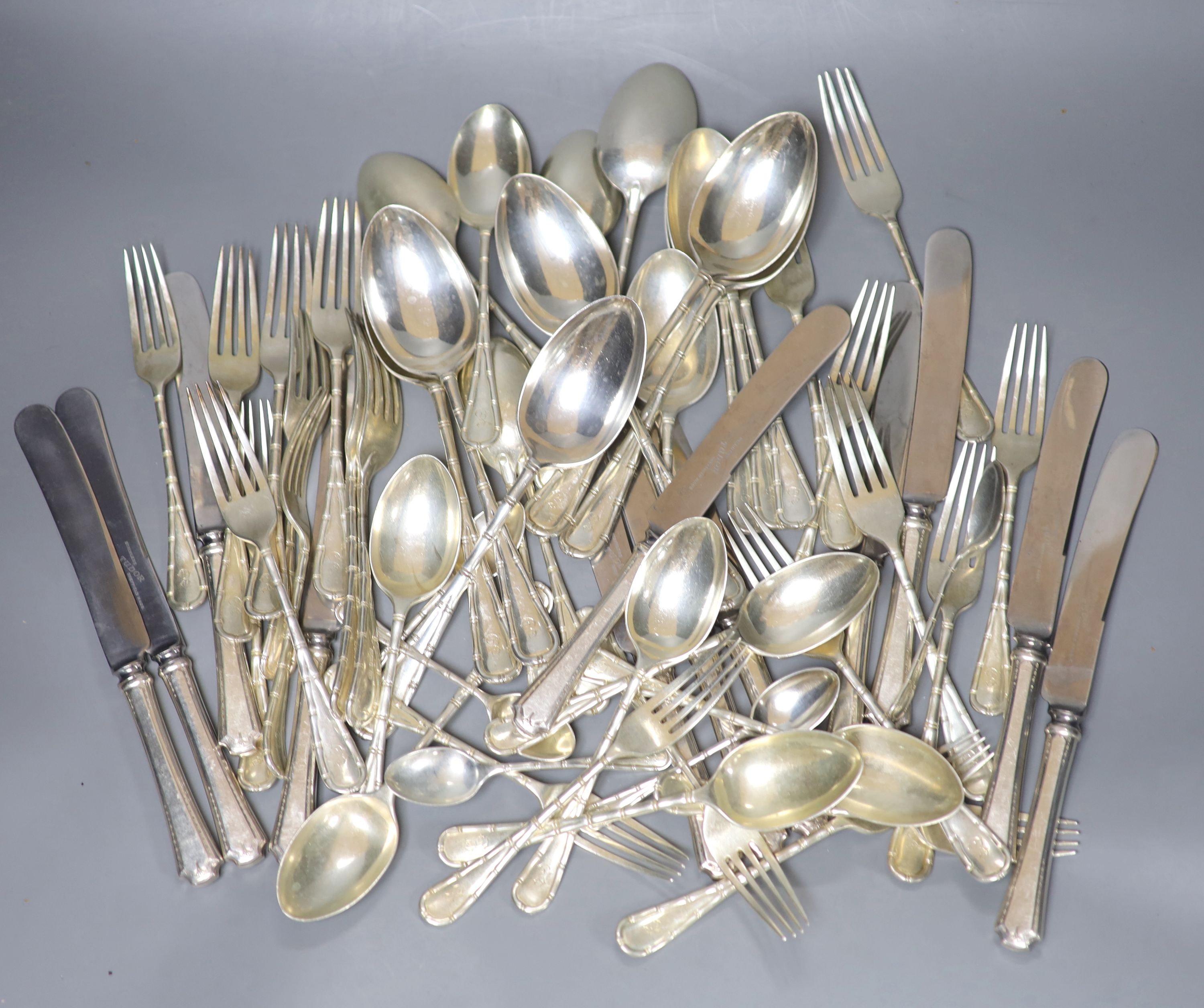 A part canteen of Edwardian silver cutlery by Atkin Brothers, Sheffield, 1903, with engraved initial, comprising forty nine items, 108oz, together with twelve later associated silver plated handled steel table knives.